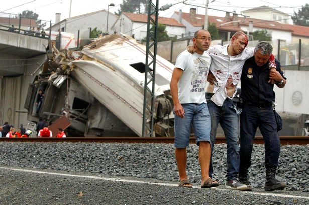 Spanish Train Crash Aftermath Leaves Questions Still Unanswered 1 A-citizen-and-a-local-police-member-rescue-a-survivor-2087320
