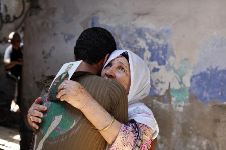 Israel releases Palestinian and Arab prisoners The mother of a Palestinian held prisoner by Israel reacts as she is hugged by her grandson in Khan Younis
