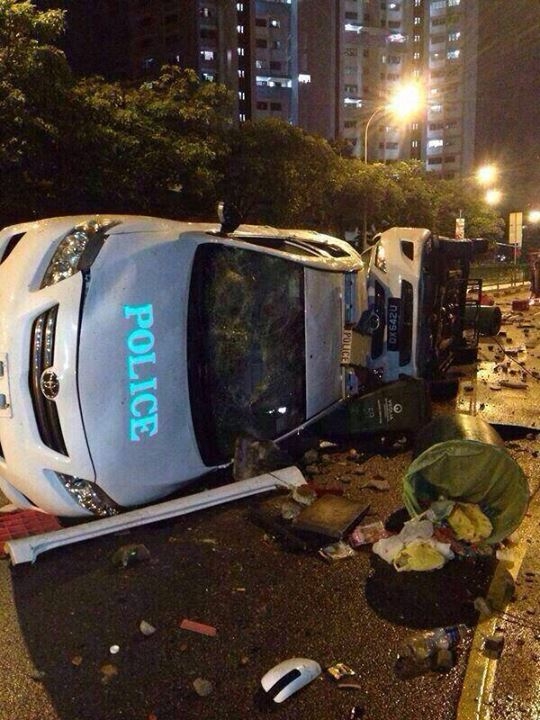Overturned police cars in Little India