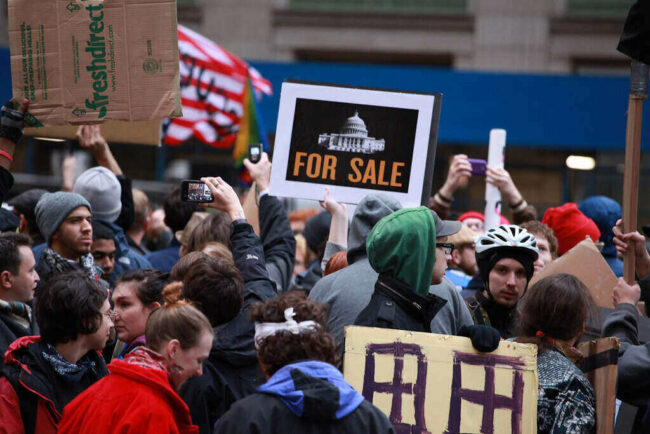 America’s Motto Changed From 'E Pluribus Unum' to 'Profit Before People' America